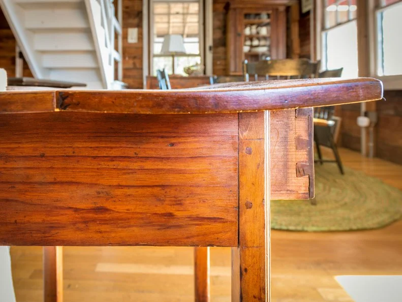 Antique wooden table with a warped top, and original joint has fractured. Possibly due to age or climate