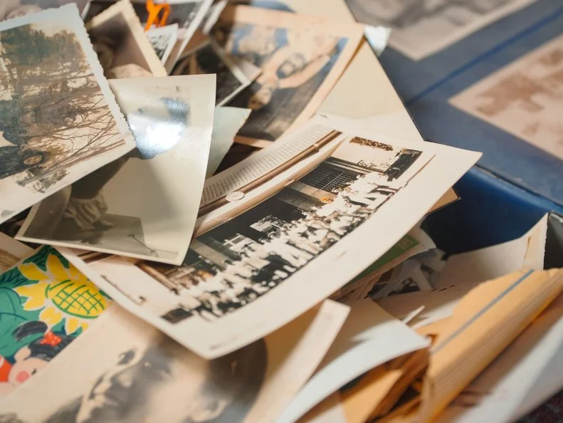 Magelang, Indonesia - September 5th 2023 : Pile of old printed photo. Vintage monochrome photographs in sepia color, genealogy concept, ancestral memory, family ties, childhood memories