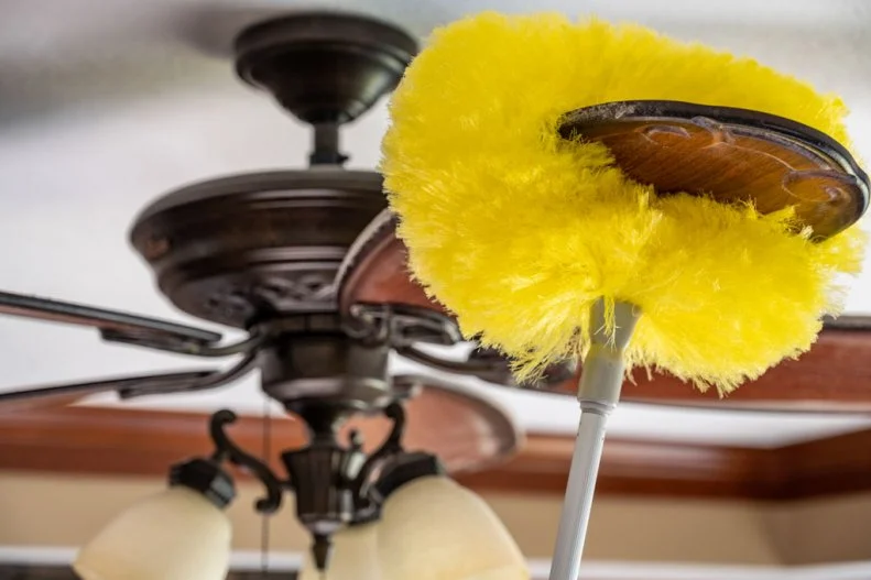 Concept of home cleaning tasks showing buildup of dust on a ceiling fan