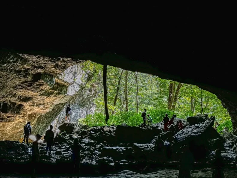 MAQUOKETA CAVES STATE PARK, September 2, 2024– landscape photo of mouth of cave with people taken on a gorgeous fall day at Maquoketa Caves near Maquoketa, Iowa.