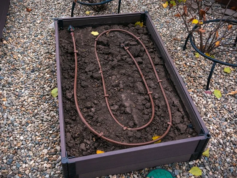 Rasied garden bed with irrigation hose